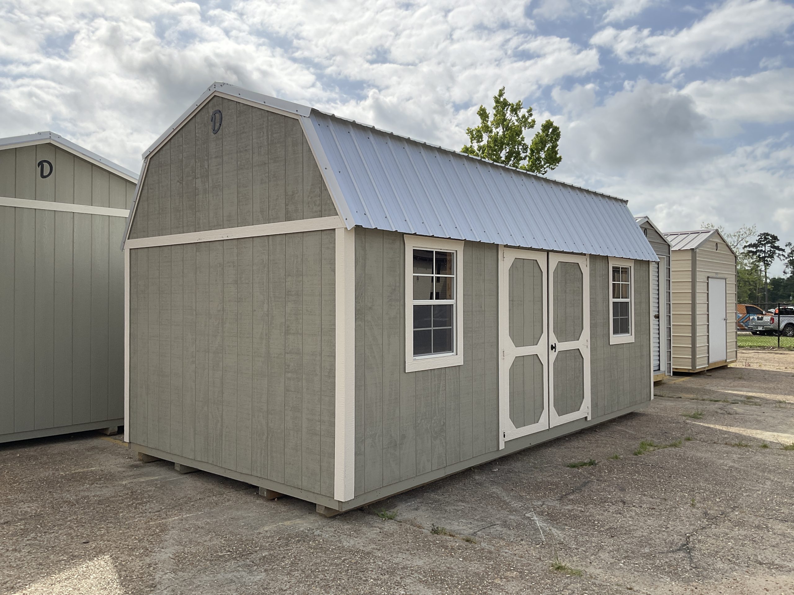 Angled view of green side lofted barn with metal roof Hammond LA