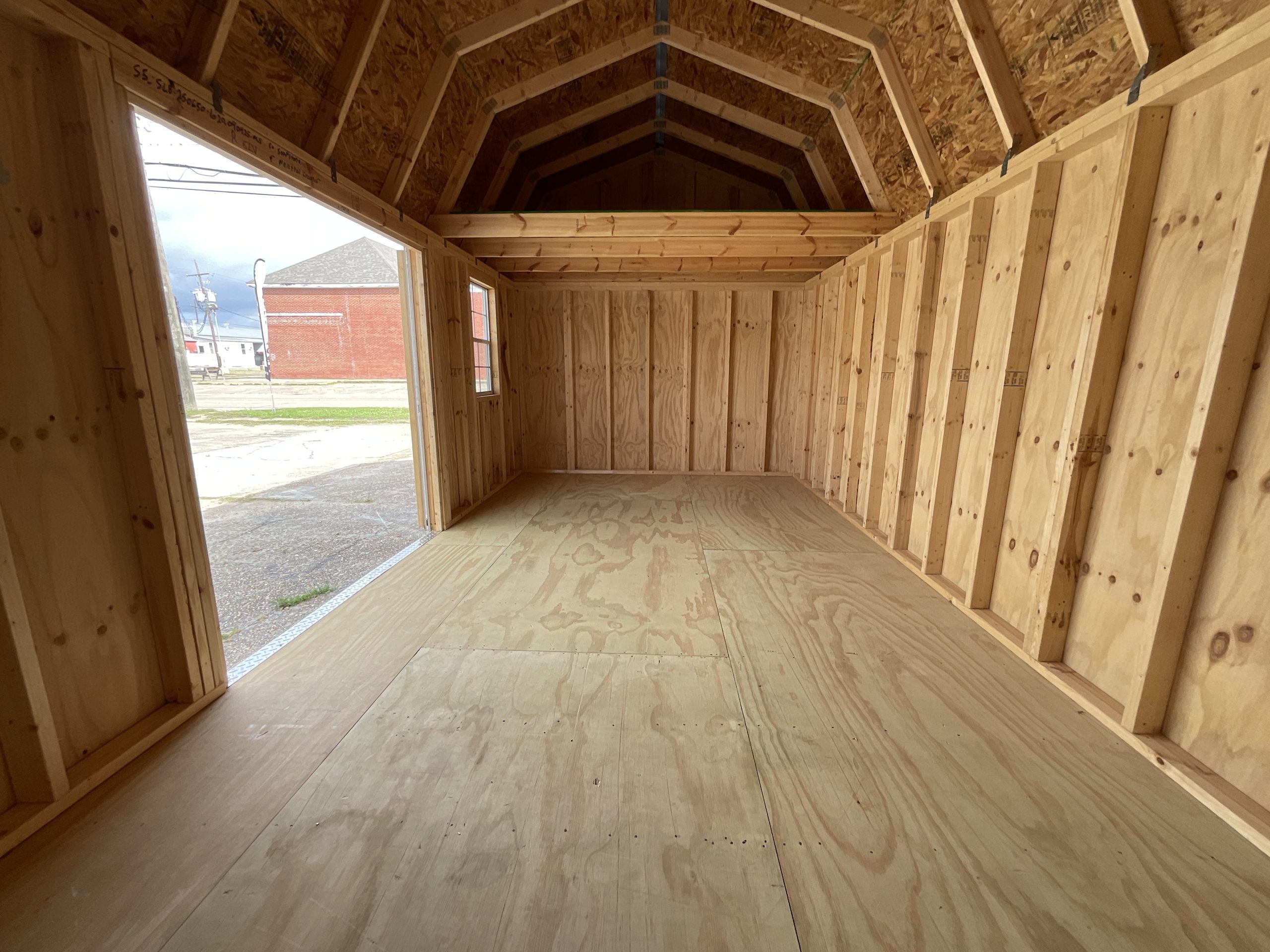 Interior view looking toward entrance of side lofted barn shed