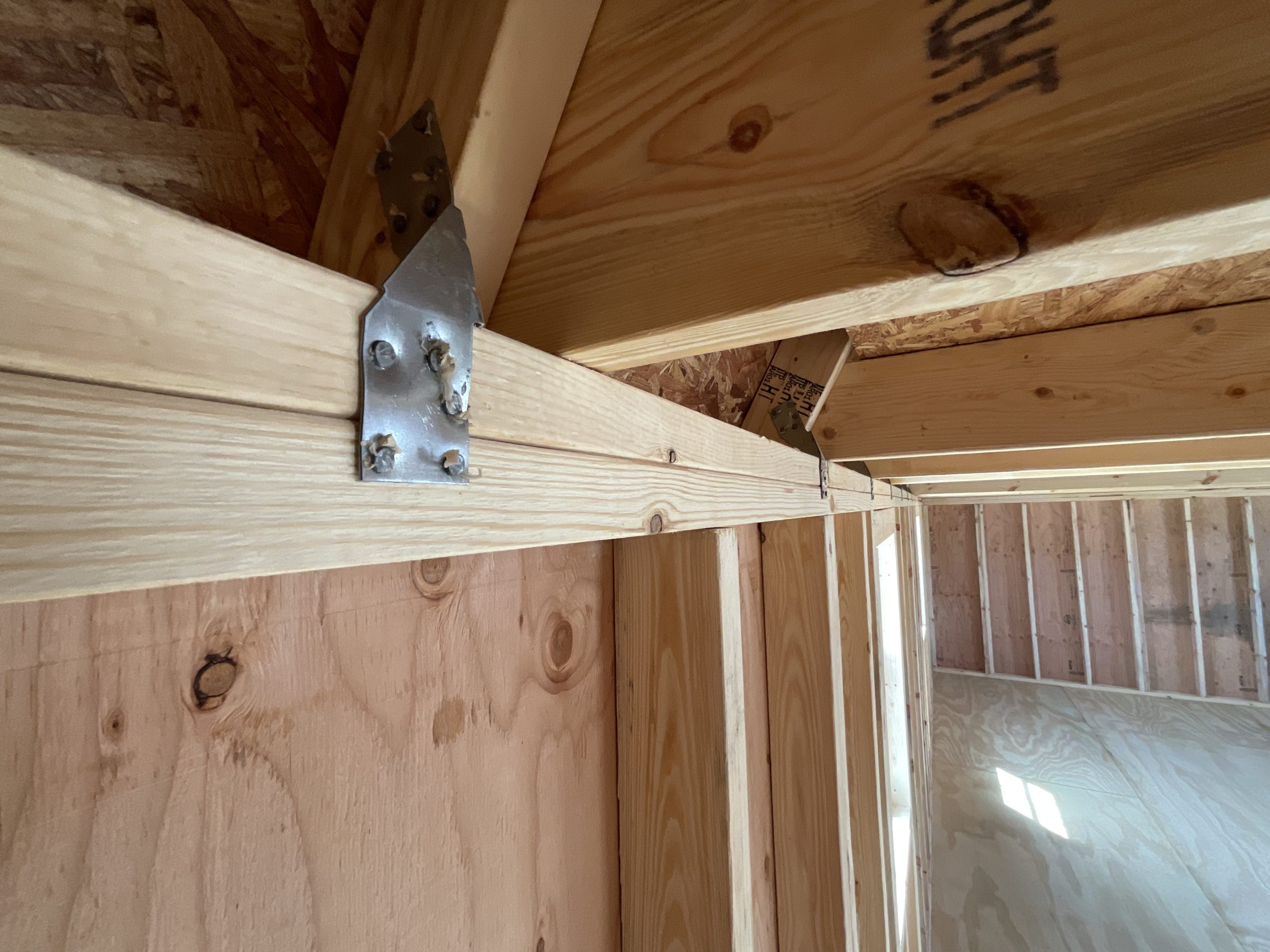 Hurricane clips securing roof trusses in lofted barn house shell Hammond LA