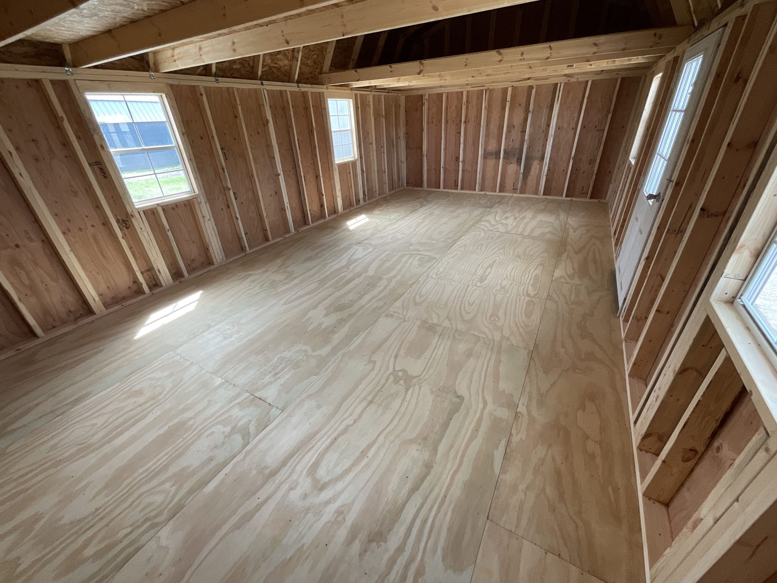 Wide interior view lofted barn with windows and door Hammond LA