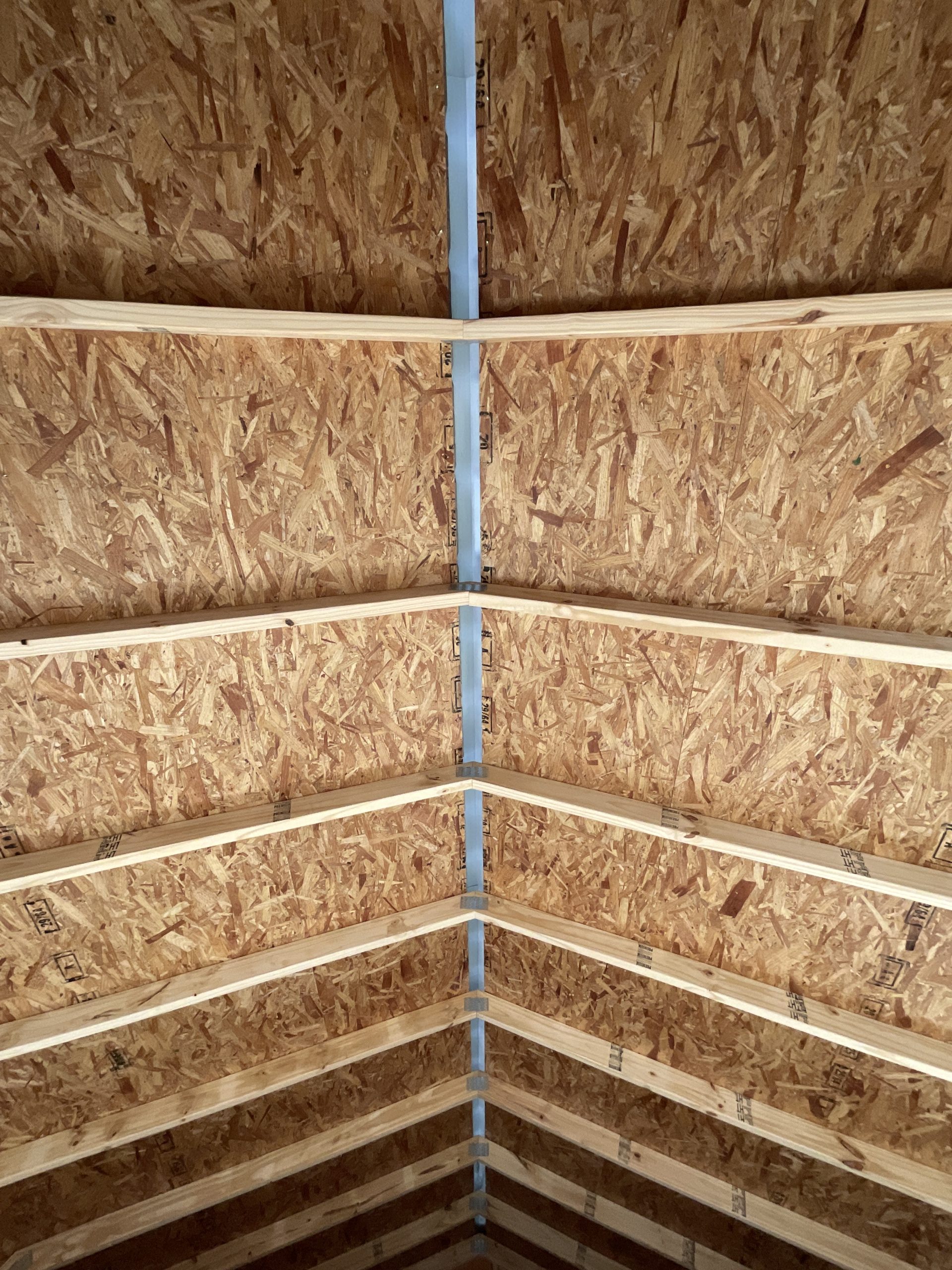 Ridge cap vent opening inside lofted barn house shell for airflow Hammond LA