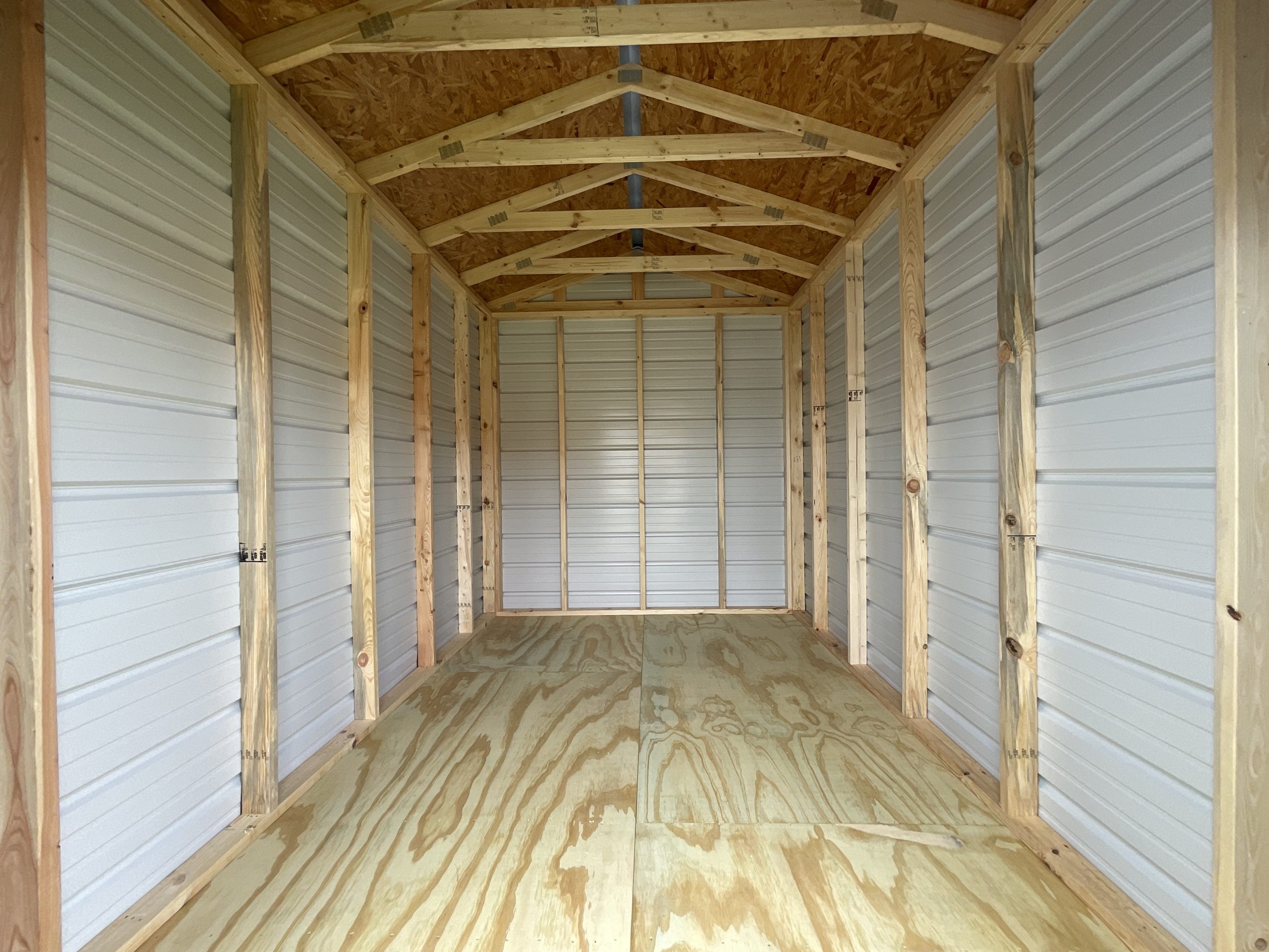 8x12 metal building interior showing wood trusses and wall framing in Hammond Louisiana storage shed