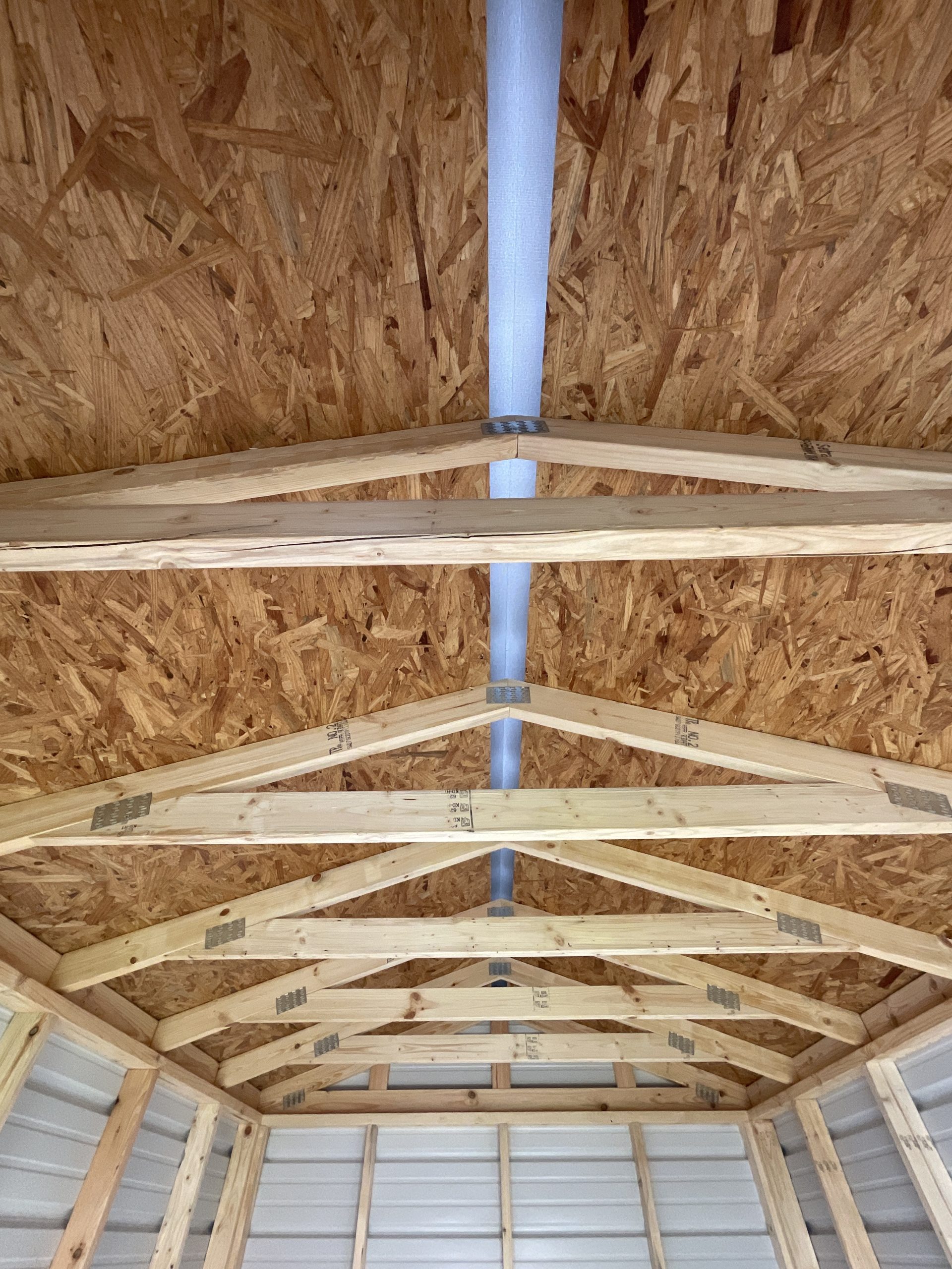 8x12 metal shed interior showing wood trusses and full length ridge cap vent in Hammond Louisiana