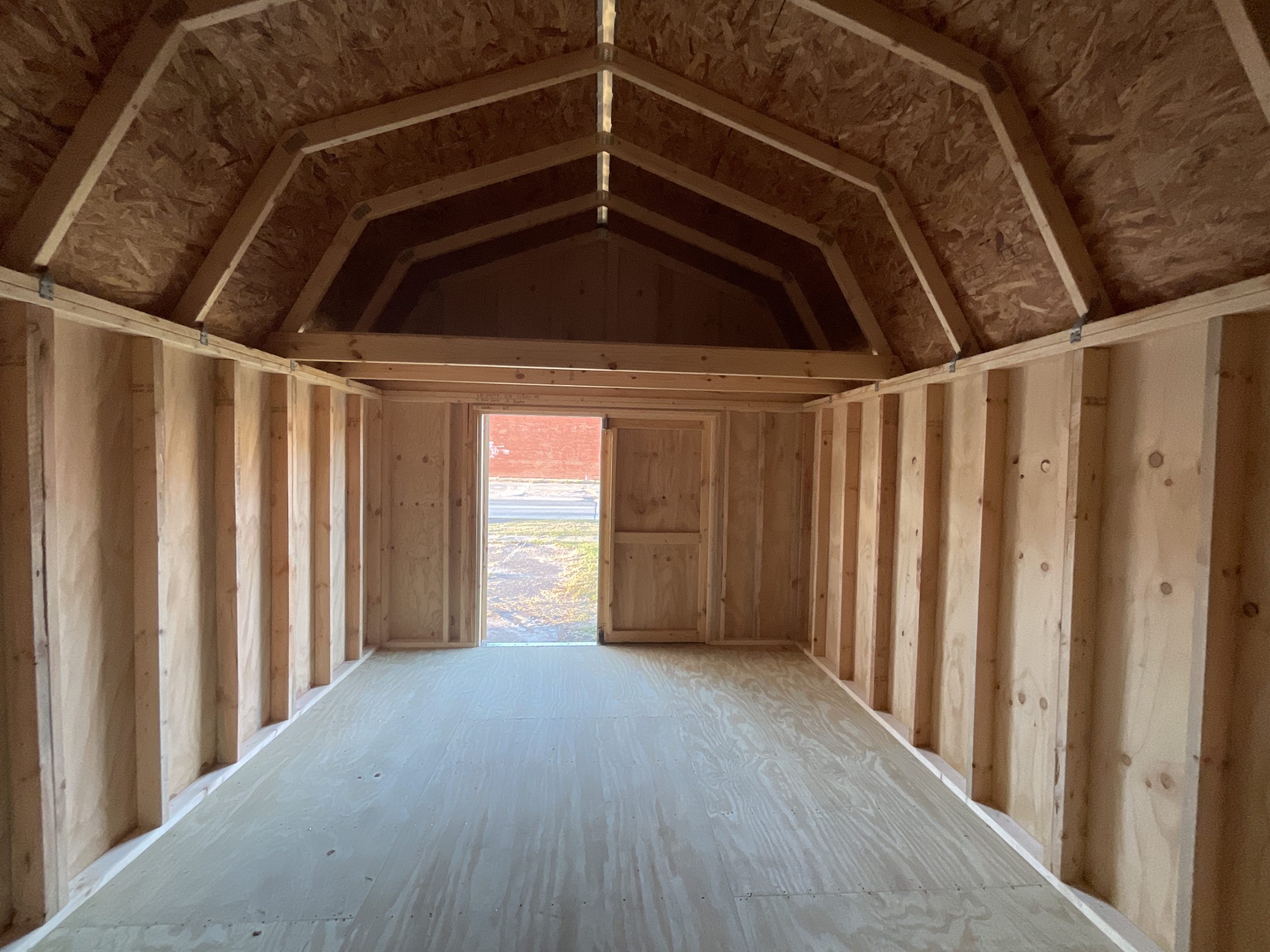 Interior storage space inside a 12x16 barn shed with lofts and treated wood floor