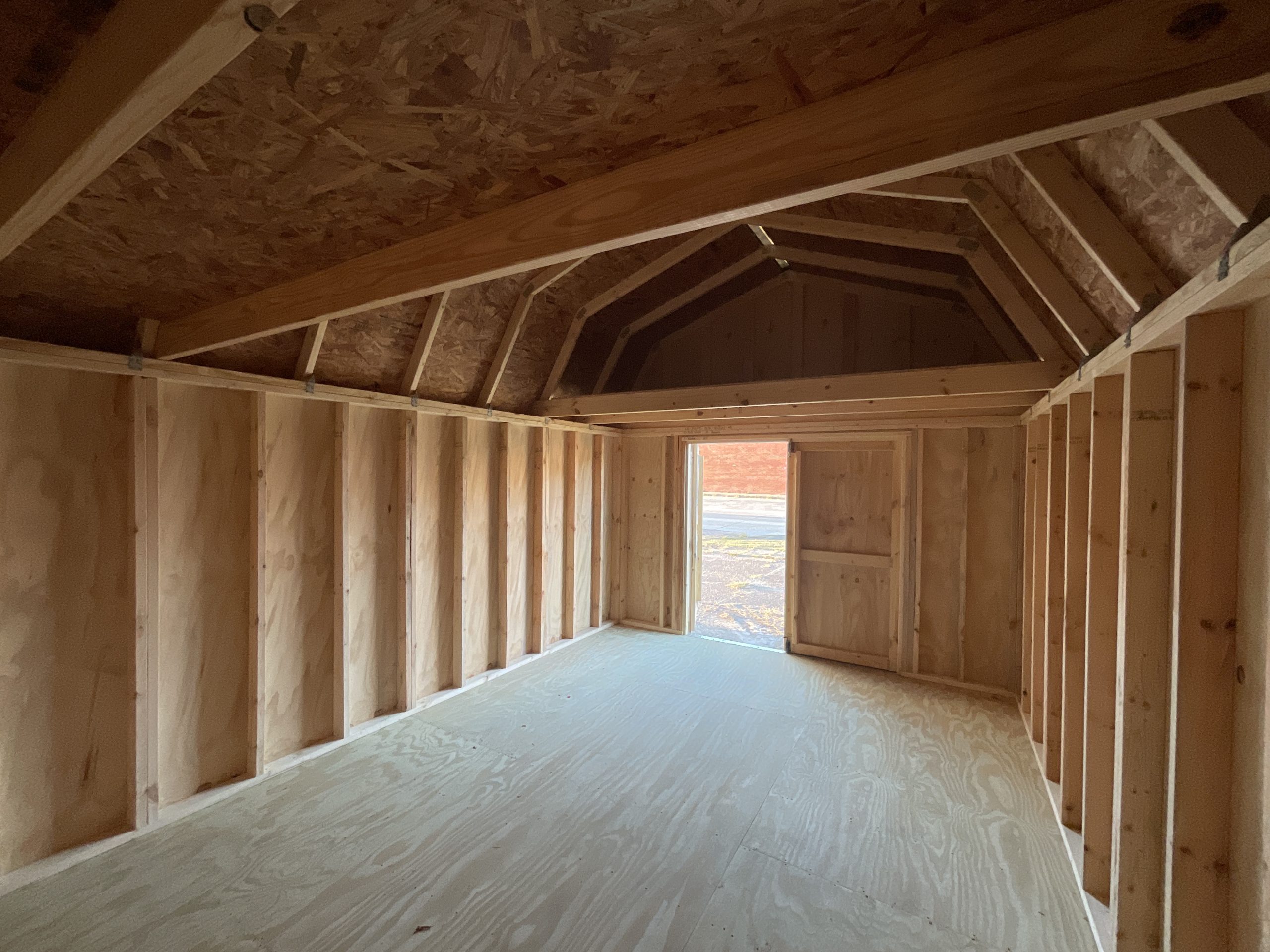 Interior view of 12x16 lofted barn showing treated tongue and groove flooring and wood framing
