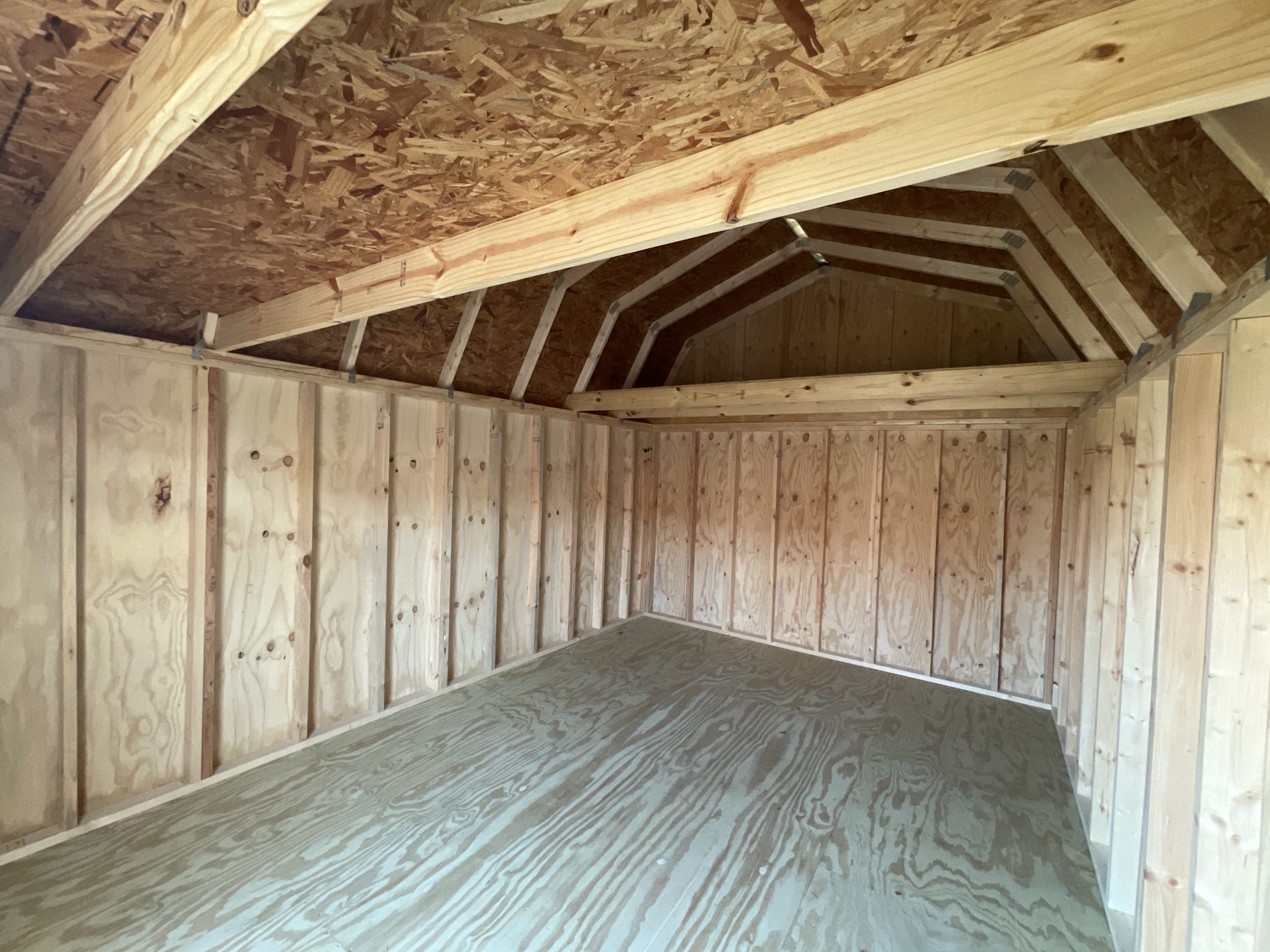 Open interior of a 12x16 lofted barn storage building with loft storage and wood framing