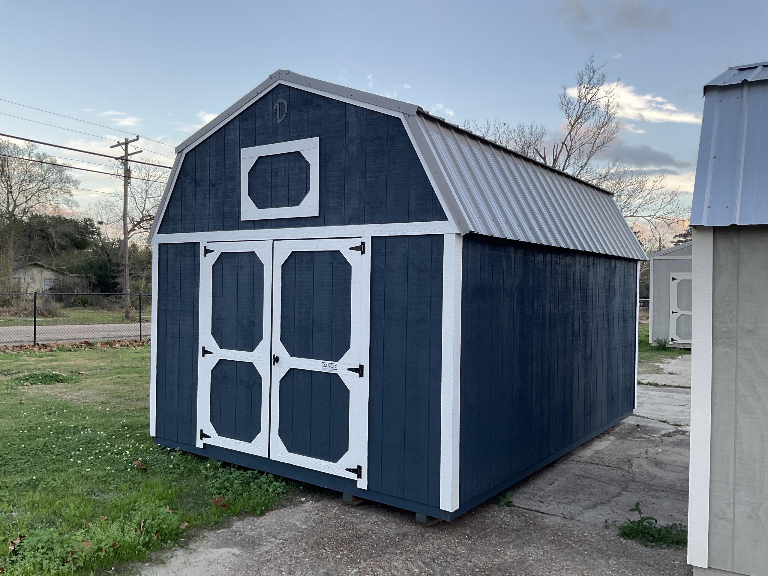 Side angle view of 12x16 lofted barn storage shed with Gale Force siding and pewter roof in Hammond Louisiana