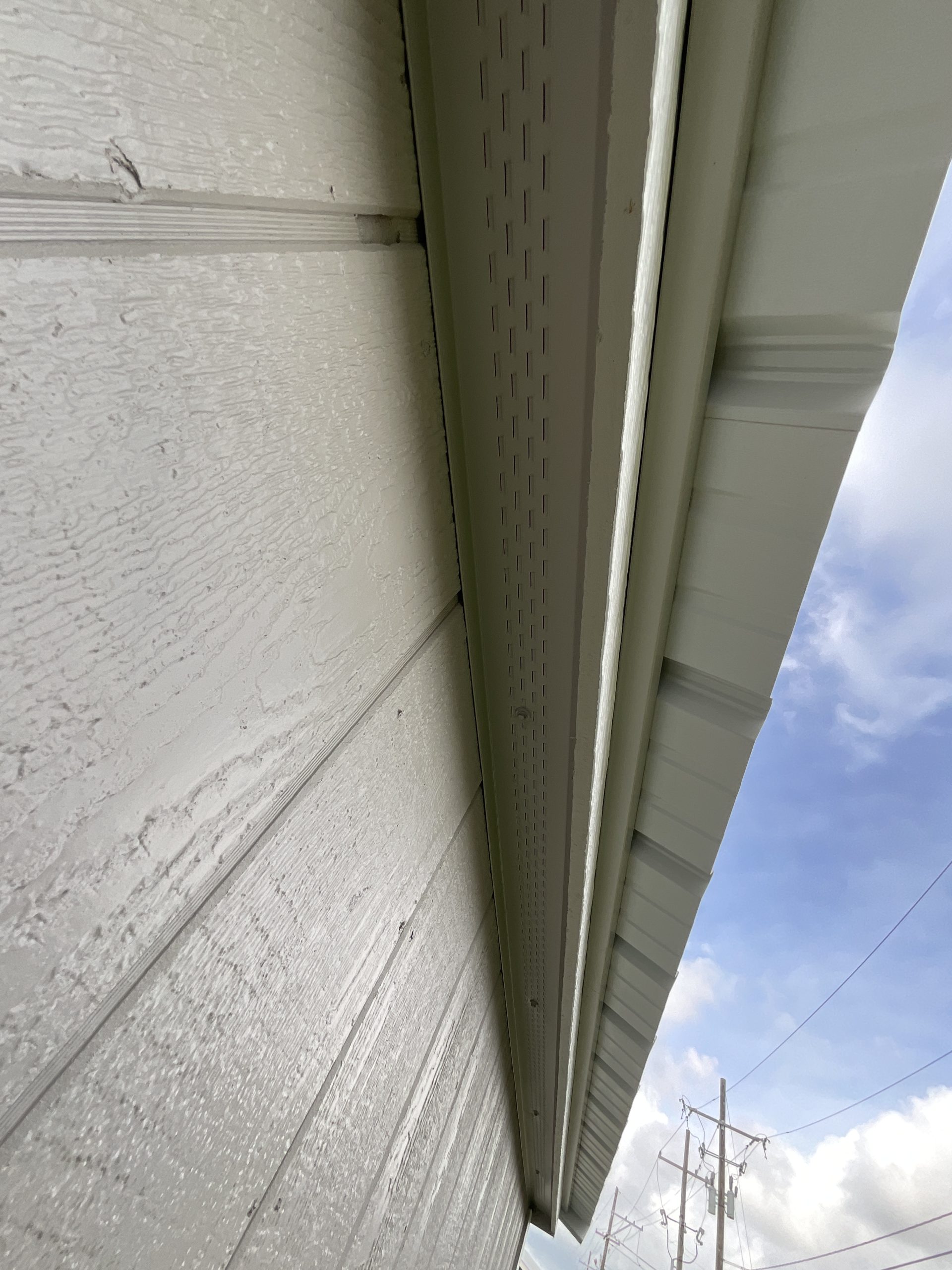Close-up of full-length soffit vent on portable garden shed roof overhang