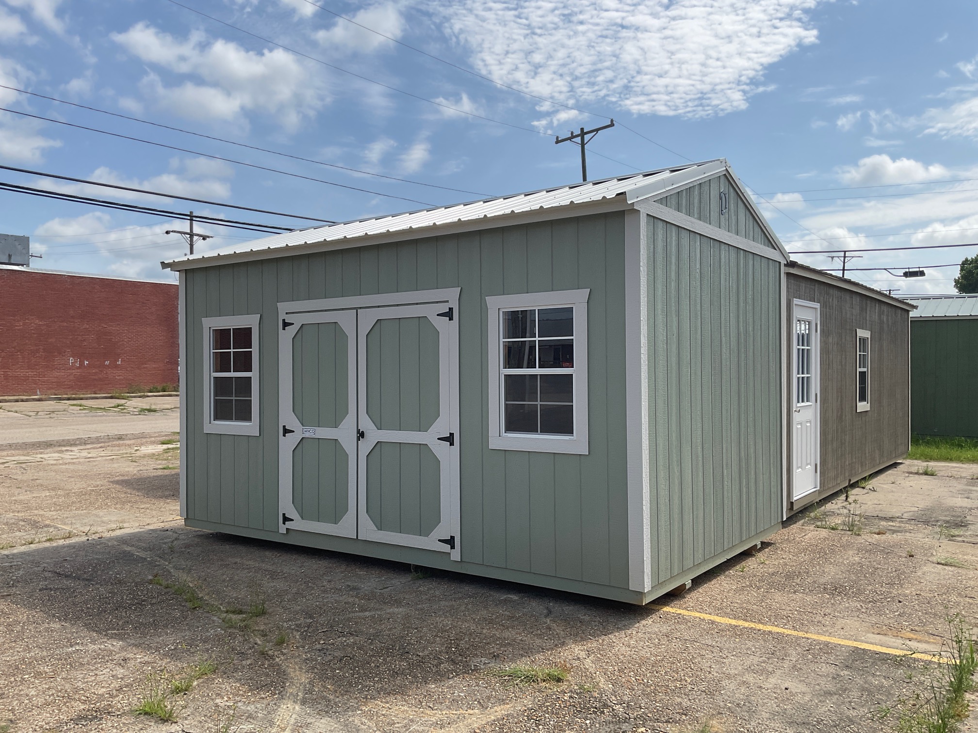 Front right exterior view of a premium 10x16 garden shed with DuraTemp engineered wood siding, metal roof, double doors, windows.