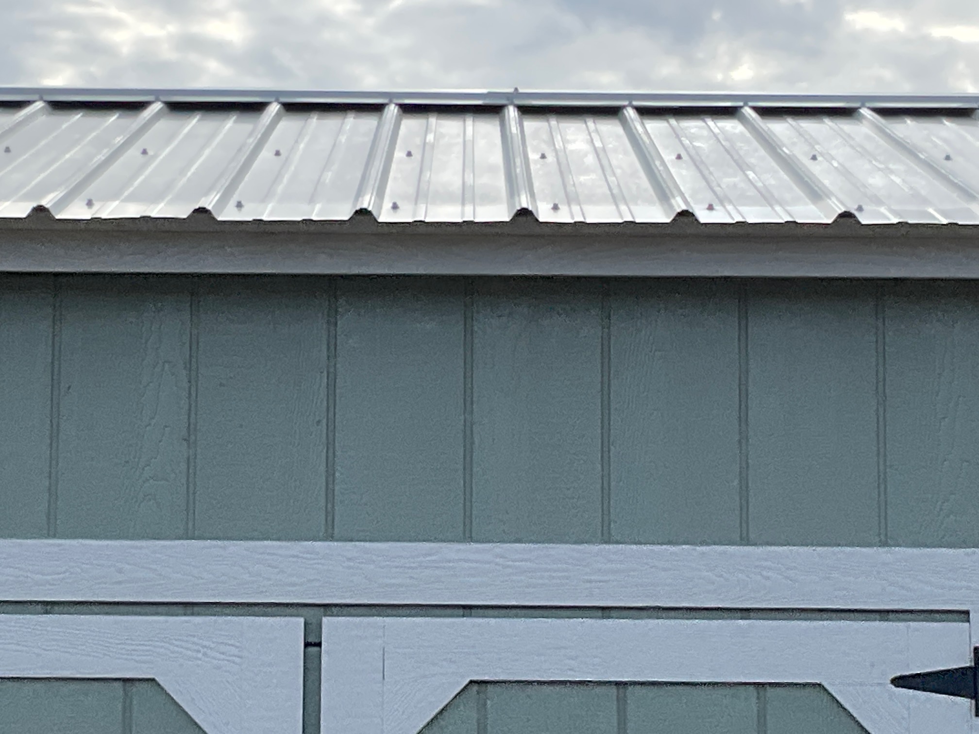 Continuous ridge-cap vent along the peak of the metal roof.