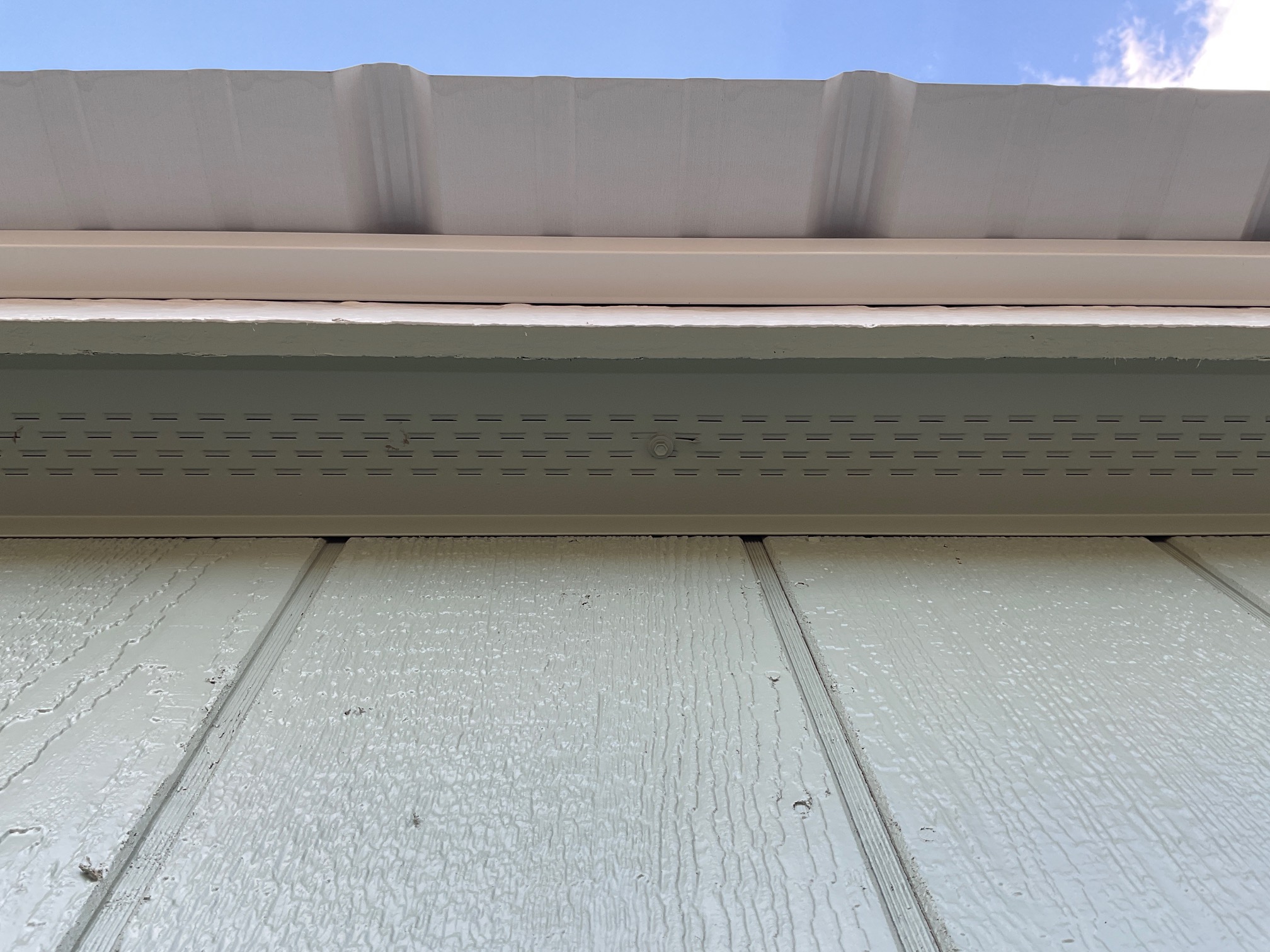 Continuous soffit vent providing airflow beneath the roof.