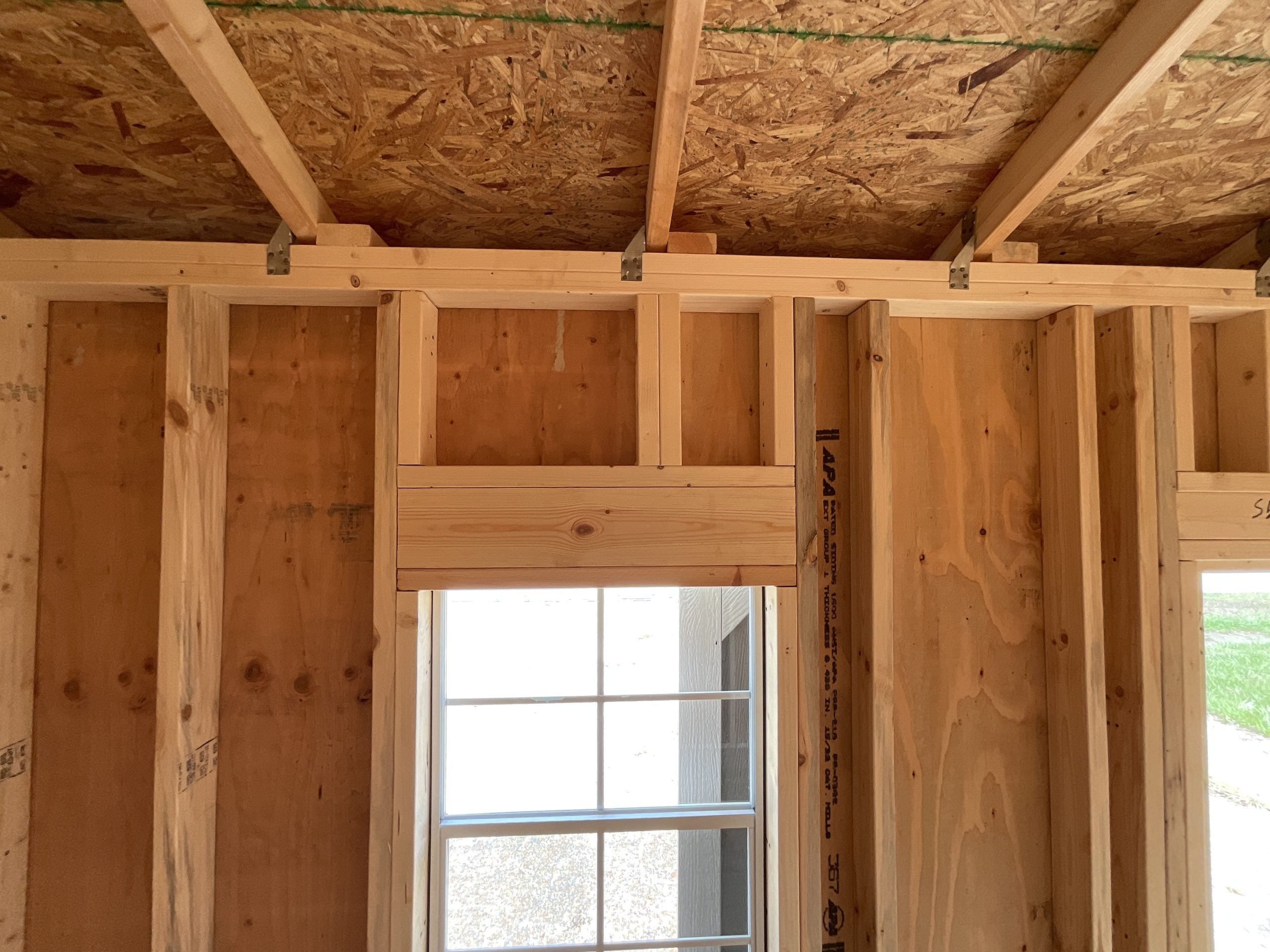 House-style wood header above window in DANCO Garden Shed