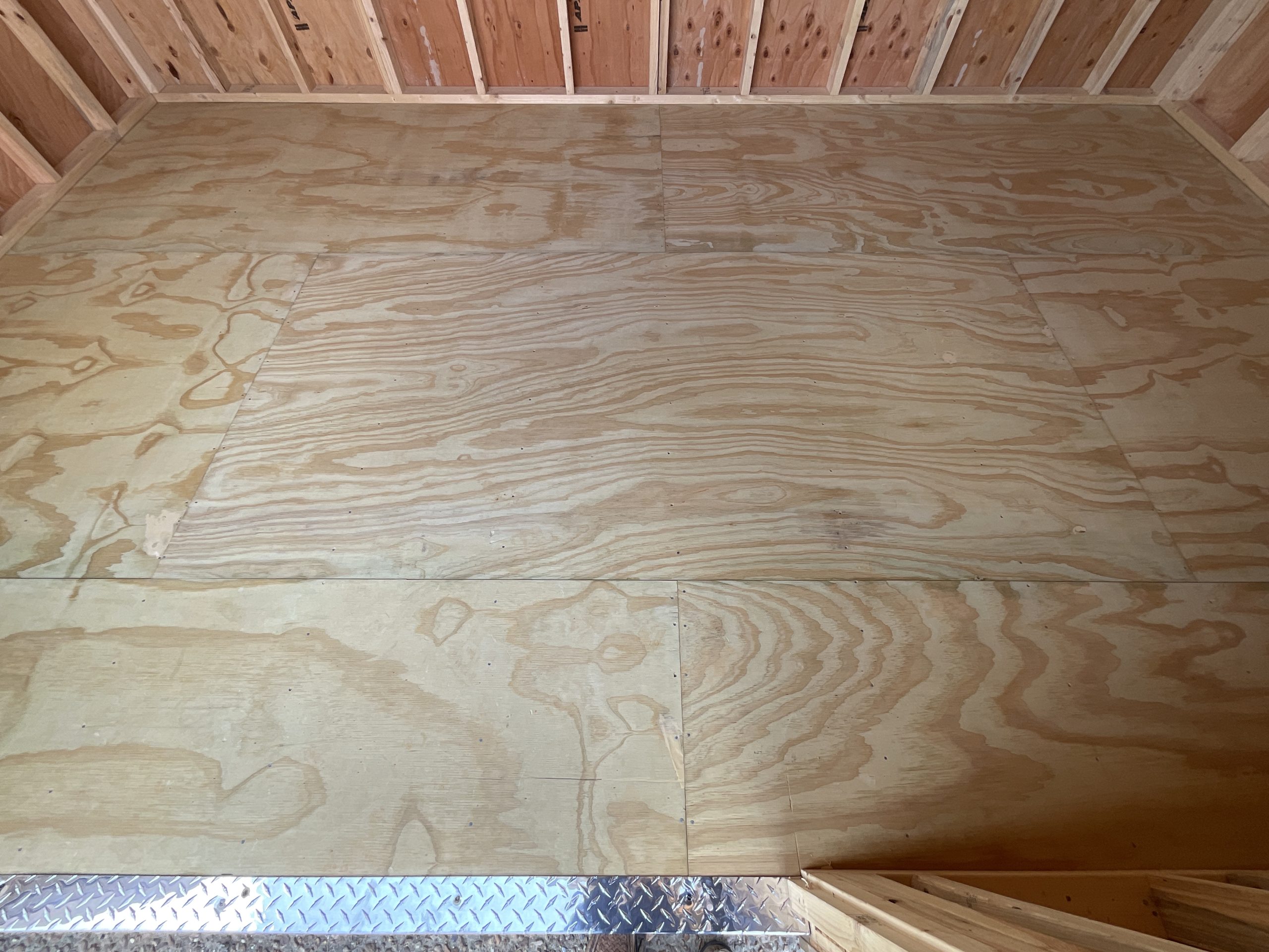 Close-up of real-wood flooring inside DANCO 10x16 storage shed