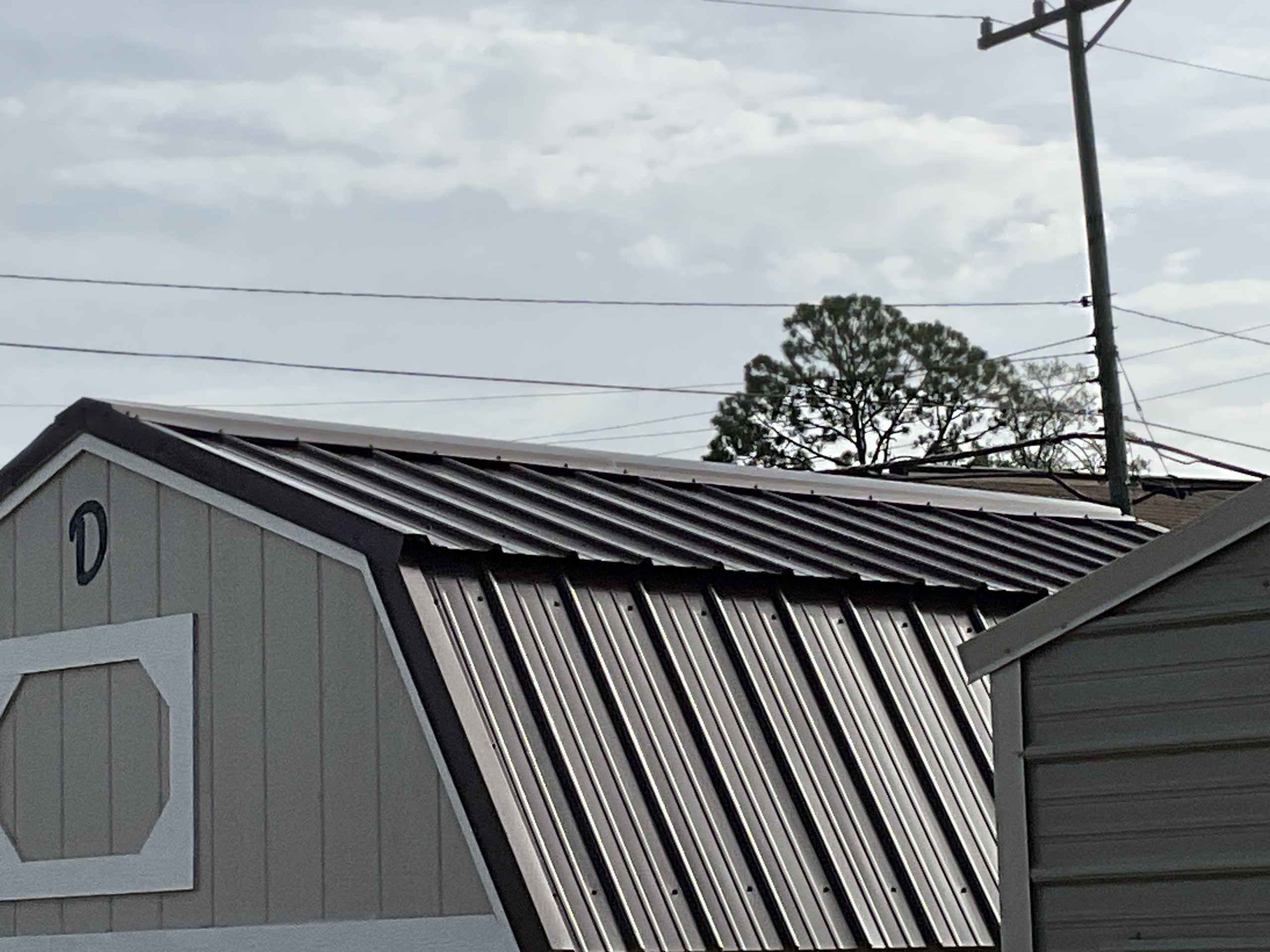 Exterior closeup of full length ridge cap vent on Lofted Barn metal roof