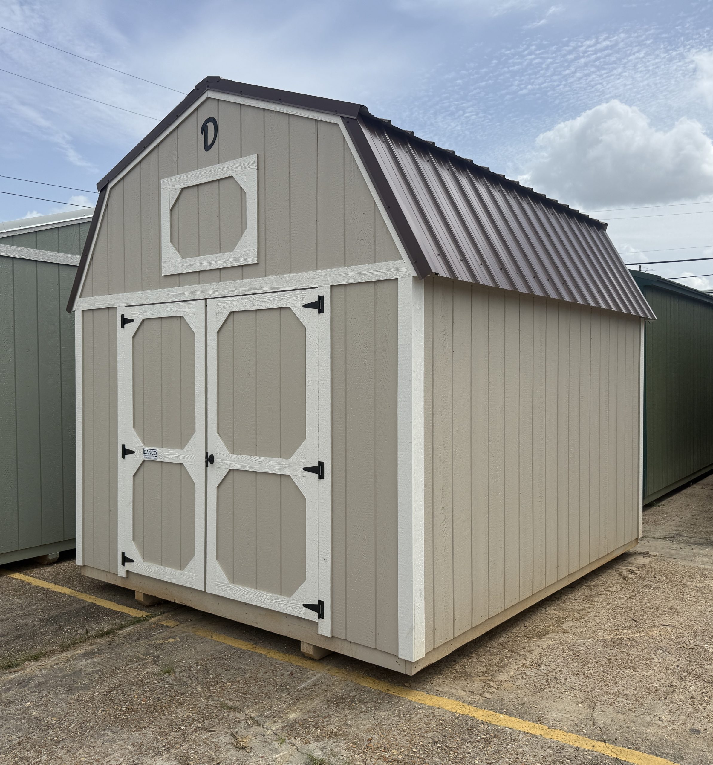10x12 Lofted Barn storage shed in Sandbar with Dover White trim and brown metal roof in Hammond LA