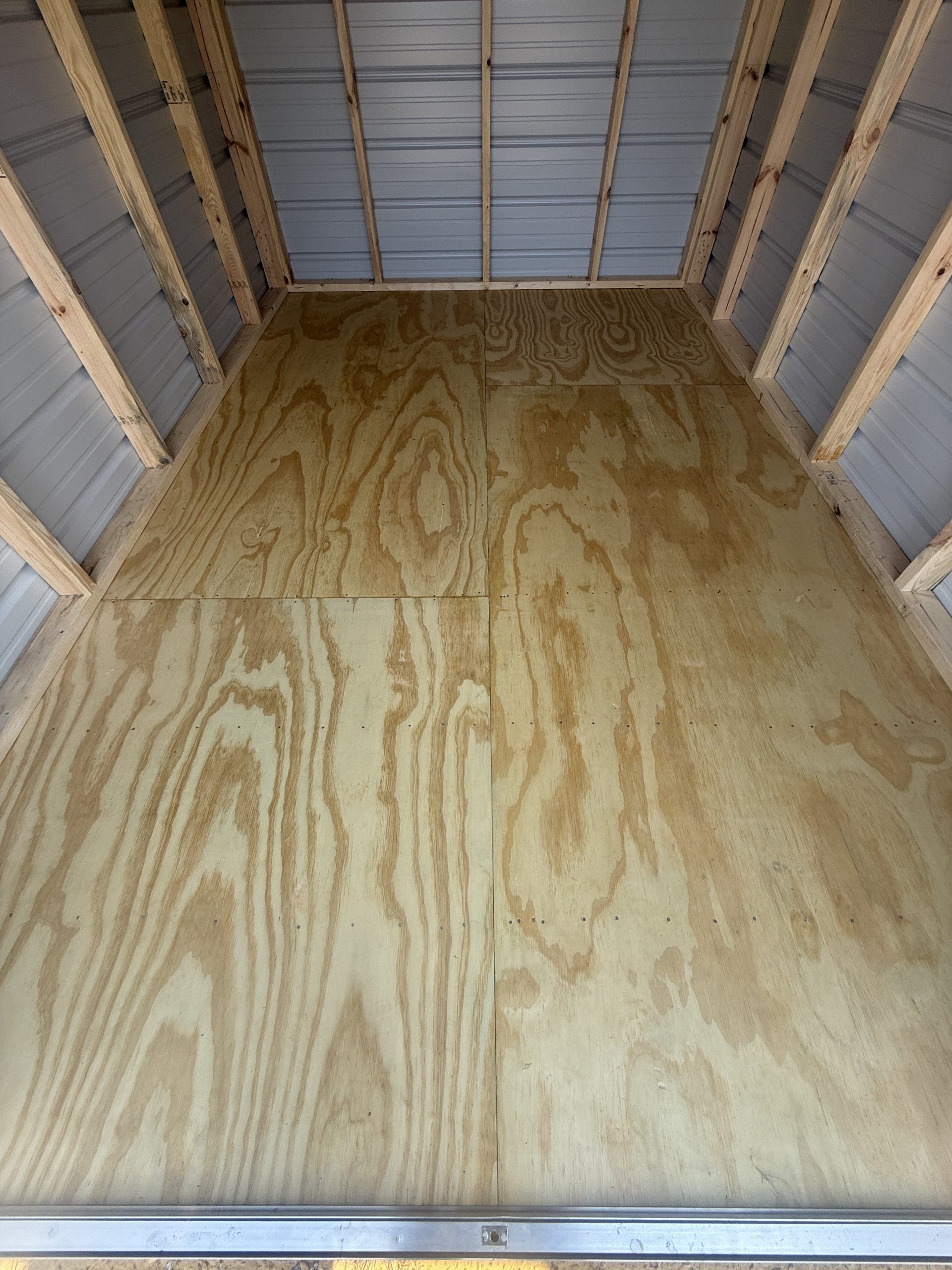 Interior of 8x12 storage shed showing treated 5/8 inch tongue and groove real wood plywood floor