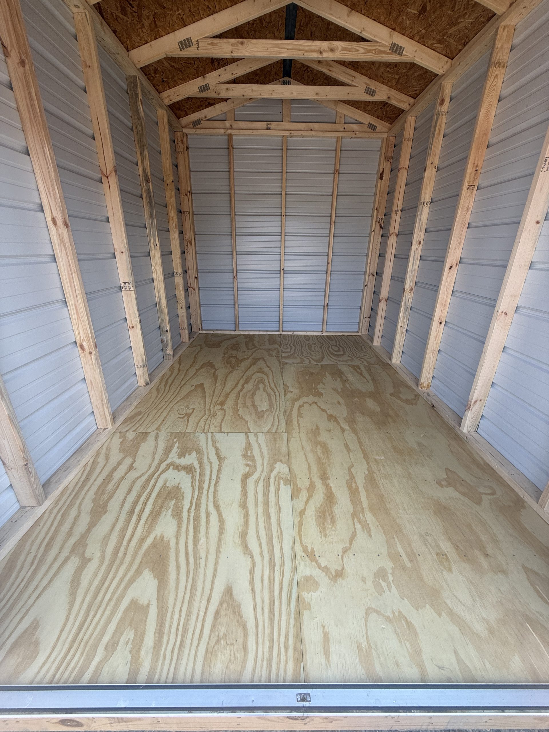 Interior view of 8x12 Utility Shed showing wood floor framed walls and usable storage space